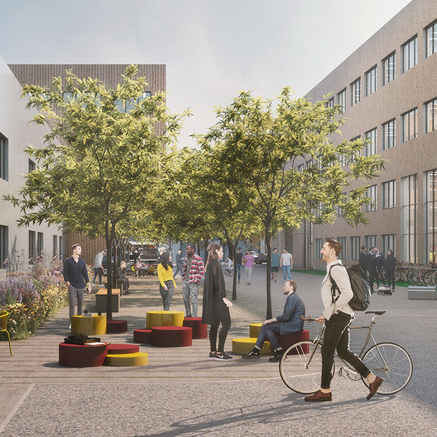 Begrünter Campus der Giesserei Garching mit Bäumen, Sitzinseln und Passanten mit Fahrrad